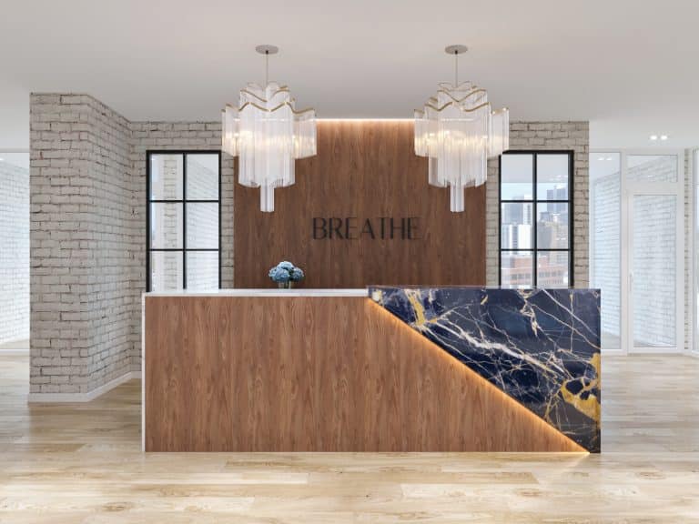 Urban and luxury-style medical office waiting area with custom marble and wood reception desk